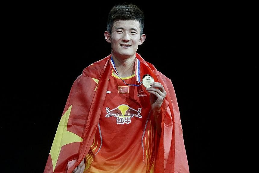 China's Chen Long celebrates with his medal after winning the men's singles final against Malaysia's Lee Chong Wei at the Badminton World Championship in Copenhagen on Aug 31, 2014. -- PHOTO: REUTERS