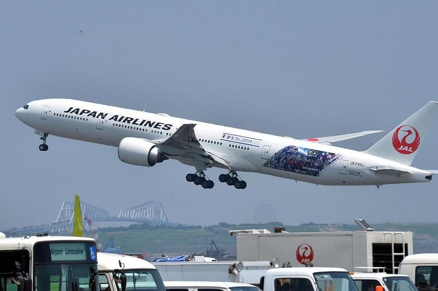 Japan Airlines (JAL) passenger jet taking off at Haneda airport in Tokyo. -- PHOTO: AFP