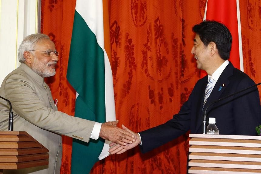 Indian Prime Minister Narendra Modi (left) shakes hands with Japanese Prime Minister Shinzo Abe after a joint press conference at Akasaka State Guest House in Tokyo on Sept 1, 2014. -- PHOTO: AFP