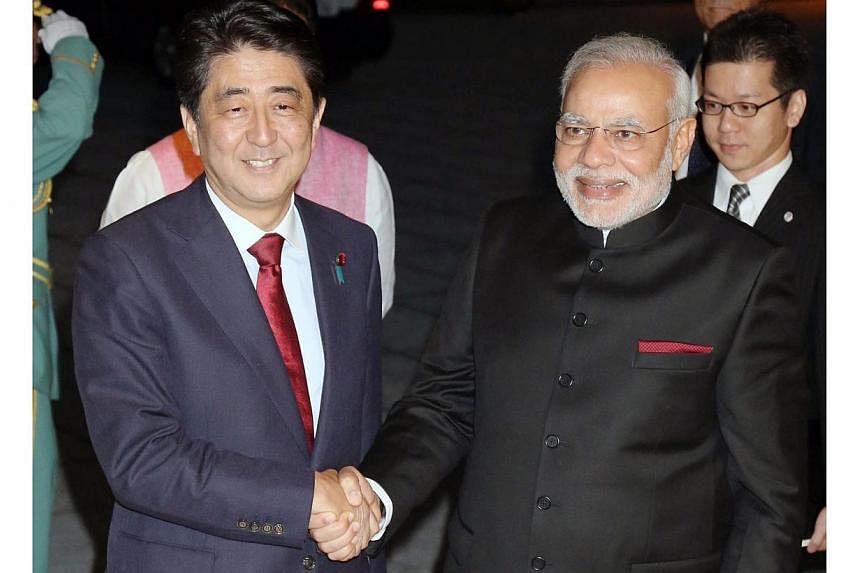 India's new Prime Minister Narendra Modi (front right) is welcomed by his Japanese counterpart Shinzo Abe upon his arrival at the State Guest House in Kyoto, western Japan, on Aug 30, 2014. -- PHOTO: AFP