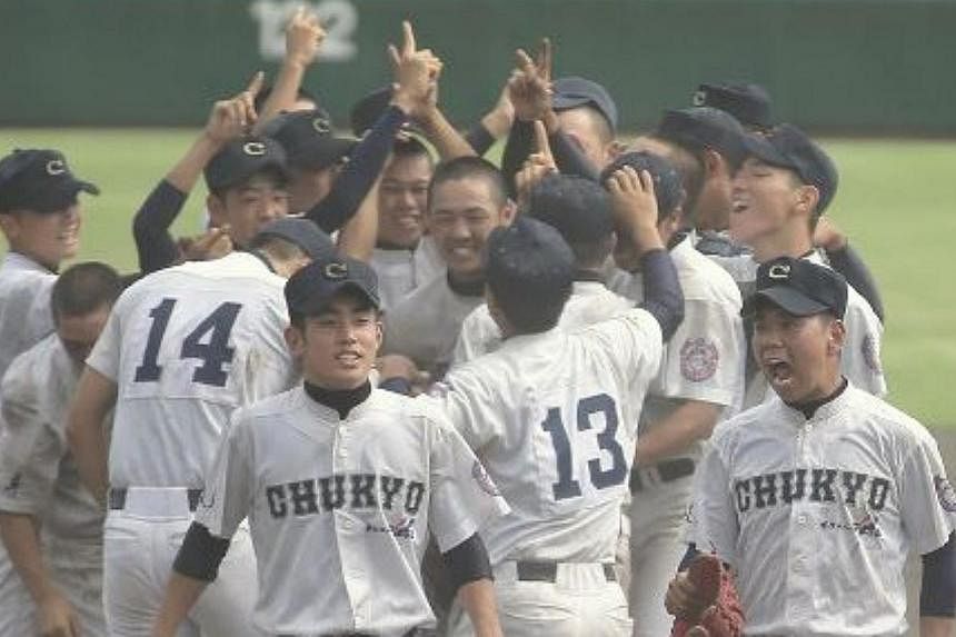 The victorious Chukyo High School team after they won their record 50-inning match against Sotoku High School that lasted four days. -- PHOTO: YOMIURI SHIMBUN/ASIA NEWS NETWORK&nbsp;