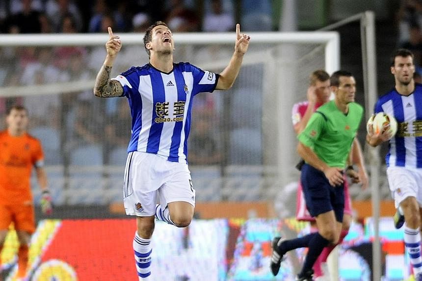 Real Sociedad's defender Inigo Martinez celebrates after scoring his team's first goal during the Spanish league football match against Real Madrid at the Anoeta stadium in San Sebastian on August 31, 2014. -- PHOTO: AFP