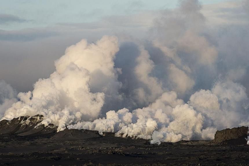 Steam and smoke rise over a 1-km-long fissure in a lava field north of the Vatnajokull glacier, which covers part of Bardarbunga volcano system, on Aug 29, 2014. -- PHOTO: REUTERS