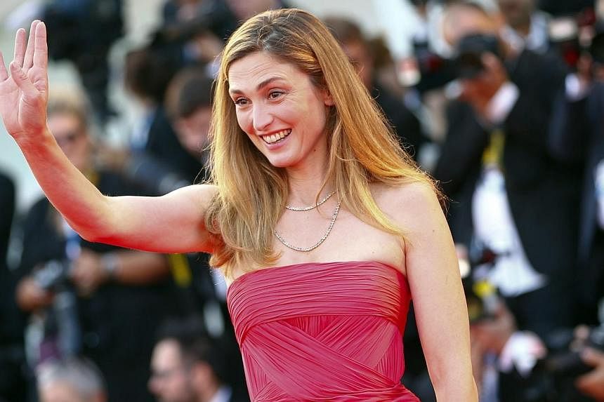 Actress Julie Gayet gestures as she arrives on the red carpet for the opening ceremony of the 71st Venice Film Festival in Venice on Aug 27, 2014.&nbsp;French actress Julie Gayet, whose affair with President Francois Hollande made headlines worldwide