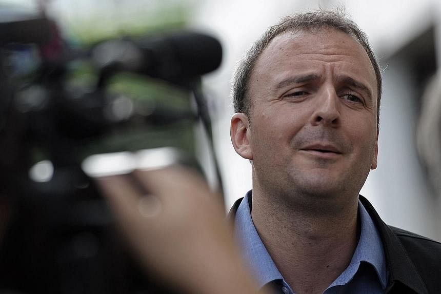 British activist Andy Hall answers reporters' questions as he arrives for a hearing at a court in Bangkok on Sep 2, 2014.&nbsp;-- PHOTO: AFP