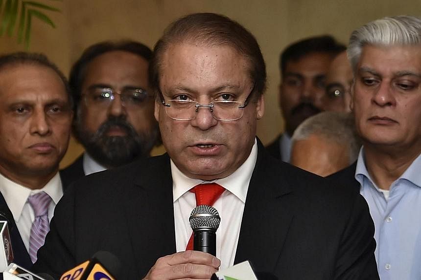 Pakistan's Prime Minister Nawaz Sharif speaks with the media during a news conference in New Delhi on May 27, 2014.&nbsp;Pakistan's parliament threw its weight behind embattled Prime Minister Nawaz Sharif on Tuesday as a deepening crisis over violent