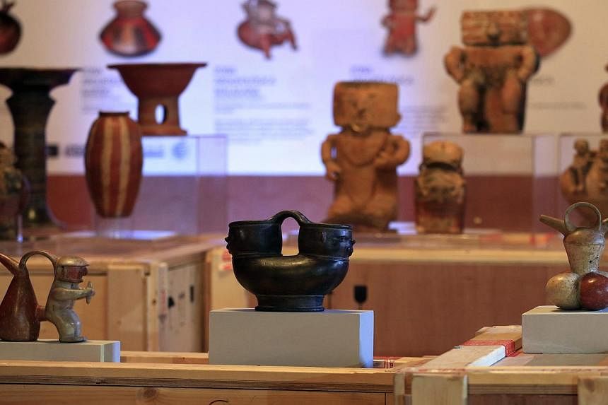 Colombian archaeological pieces are displayed as part of an exhibition at a media preview at the Foreign Ministry building in Bogota on Sept 1, 2014. -- PHOTO: REUTERS