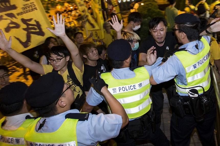 Pro-democracy activists clash with the police during a protest outside the hotel where China's National People's Congress (NPC) Standing Committee Deputy General Secretary Li Fei is staying, in Hong Kong on Sept 1, 2014. -- PHOTO: REUTERS