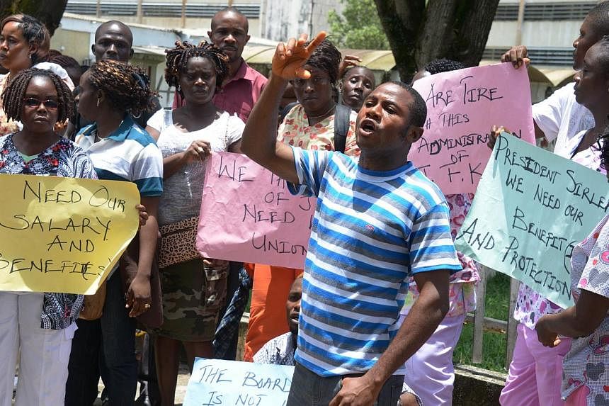 Medical workers of the John Fitzgerald Kennedy hospital of Monrovia protest during a strike for salaries and better security against Ebola virus epidemic on Sept 1, 2014. -- PHOTO: AFP