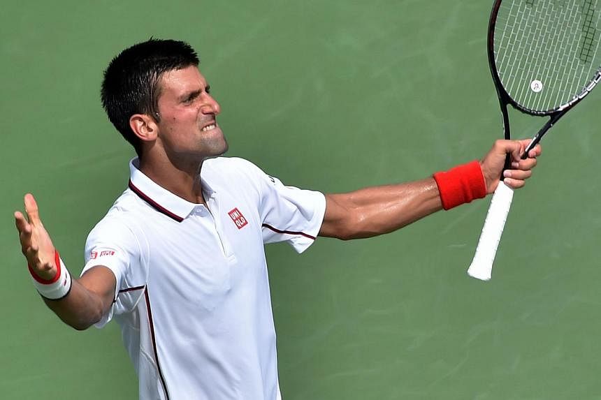 Novak Djokovic of Serbia celebrates a point against Philipp Kohlschreiber of Germany during their 2014 US Open men's singles match at the USTA Billie Jean King National Tennis Center in New York on Sept 1, 2014. -- PHOTO: AFP