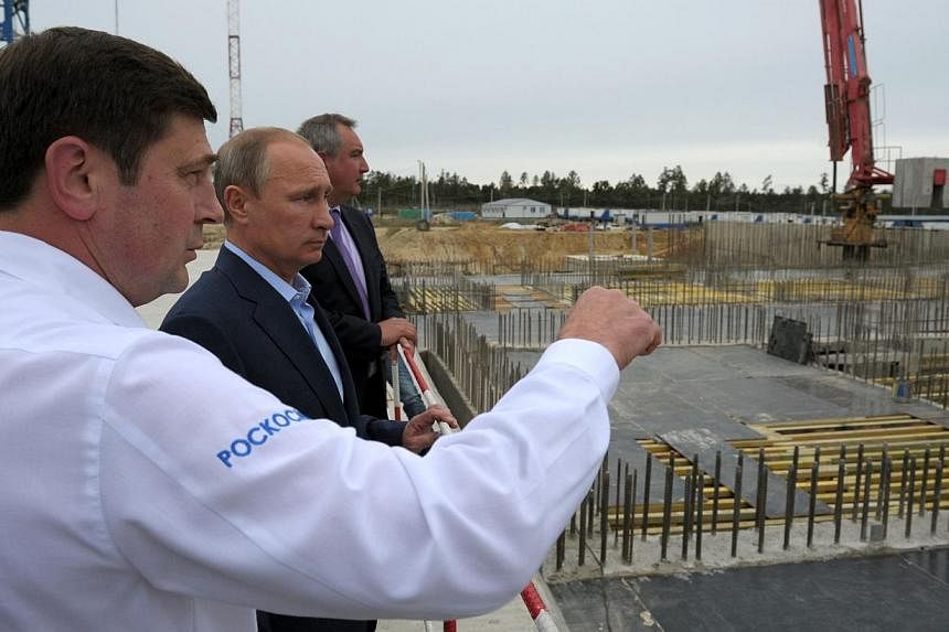 Russian President Vladimir Putin (second from left) listening to head of the Russian Space Agency Oleg Ostapenko (left) during a visit to the Vostochny Cosmodrome near the town of Uglegorsk on September 2, 2014. Mr Putin&nbsp;on Tuesday ordered const