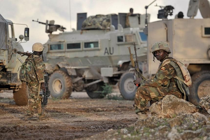 A handout picture taken on Aug 31, 2014 by the African Union-United Nations Information Support Team shows Ugandan soldiers, as part of the African Union Mission in Somalia, resting in the town of Kurtunwaarey in the Lower Shabelle region of Somalia 