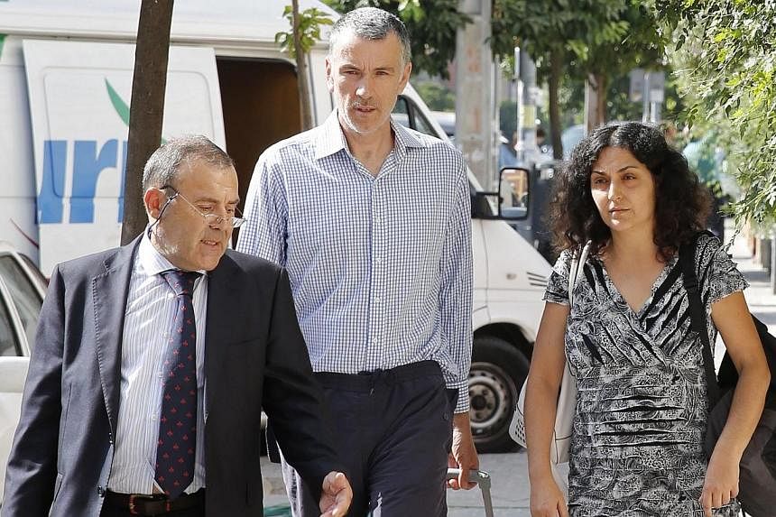 Naghemeh (right) and Brett King (centre), parents of Ashya King, walk before attending a news conference with their lawyer Juan Isidro Fernandez (right) in the Andalusian capital of Seville, Sept 3, 2014.&nbsp;British boy Ashya King is due to receive