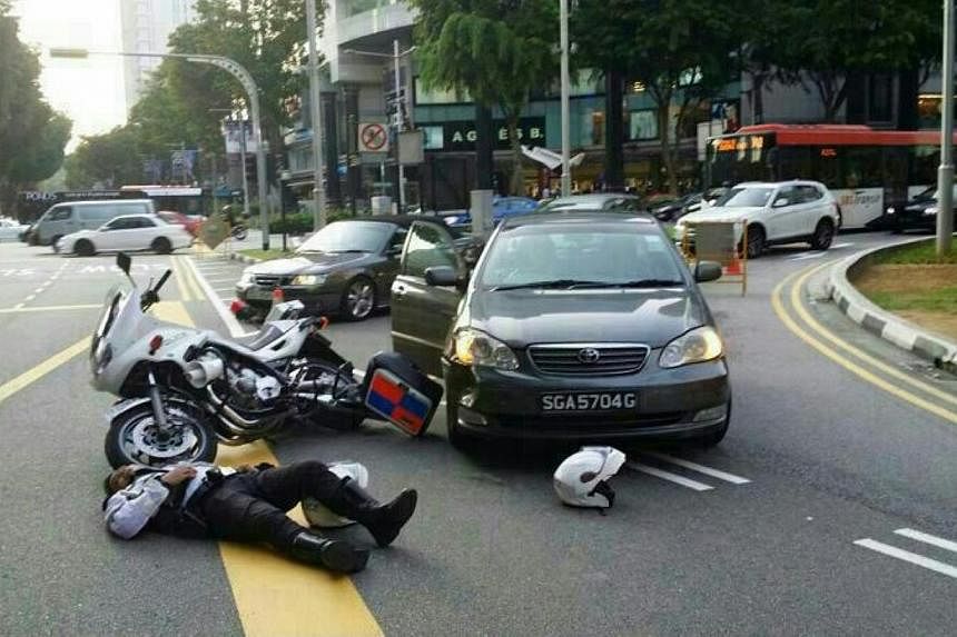 A traffic police officer was involved in a collision with a car yesterday at the junction of Scotts Road and Orchard Road.&nbsp;-- PHOTO: STOMP