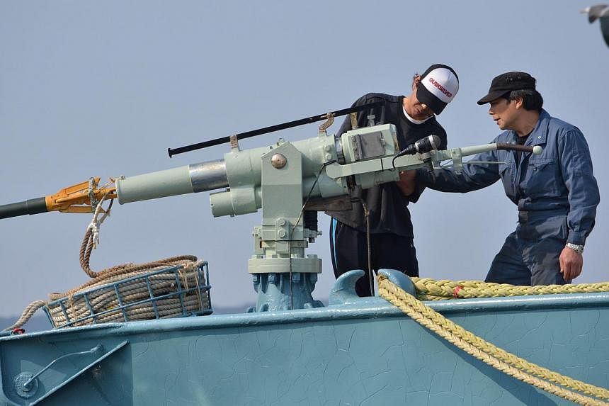 This file picture taken on April 26, 2014, shows crew members of a whaling ship checking a whaling gun or harpoon before departure at Ayukawa port in Ishinomaki City, northern Japan.&nbsp;Japan plans to resume its slaughter of minke whales in the Ant