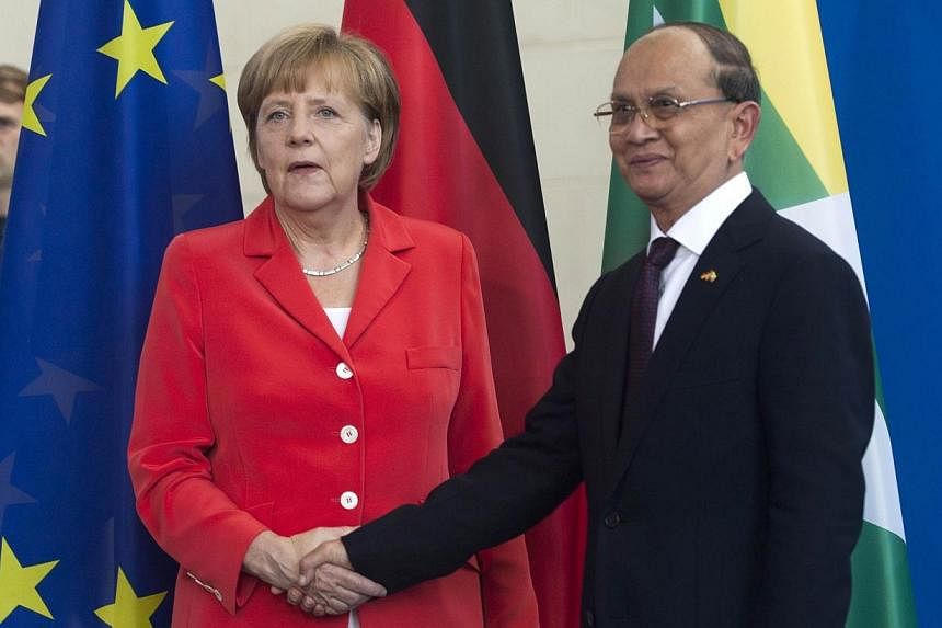 German Chancellor Angela Merkel greets the President of Myanmar Thein Sein on his arrival for a meeting at the Chancellery in Berlin on Wednesday, Sept 3, 2014.&nbsp;Dr Merkel on Wednesday pledged further economic support for Myanmar if it holds fair