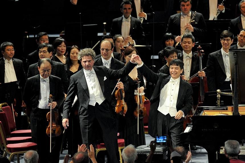 The SSO performed at the BBC Proms, conducted by Shui Lan (right, in front) with Andreas Haefliger(left, in front) on piano. -- PHOTO:&nbsp;BBC/CHRIS CHRISTODOULOU