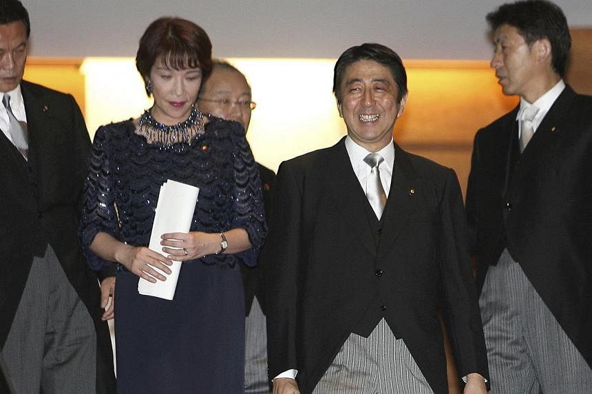 From left, Japanese Foreign Minister Taro Aso, Gender Equality Minister Sanae Takaichi, Justice Minister Jinen Nagase, Prime Minister Shinzo Abe, and Chief Cabinet Secretary Yasuhisa Shiozaki. Abe named five women to his new cabinet on Sept 3, which 