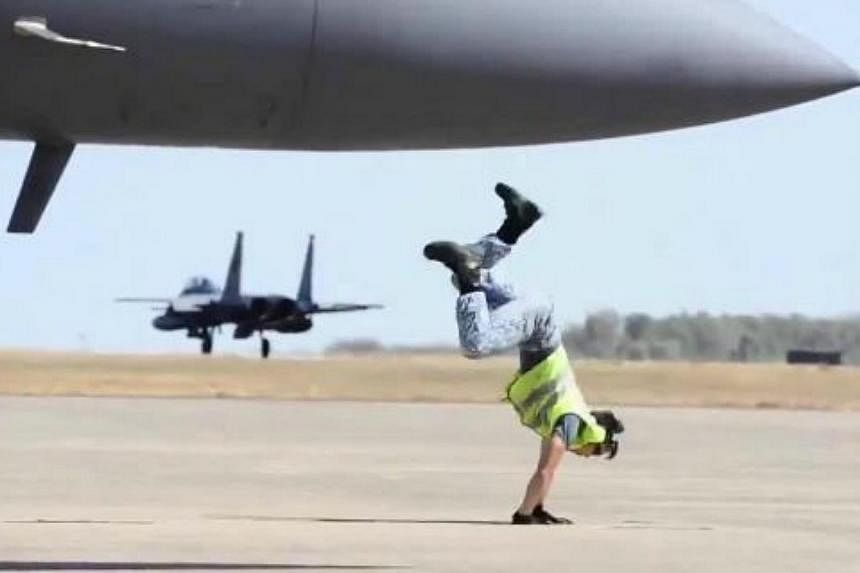A video featuring a Republic of Singapore Air Force (RSAF) marshaller pulling off a series of slick breakdancing moves including a windmill, cartwheel and backflip - all as he points an airplane into flight - has gone viral. -- PHOTO: REPUBLIC OF SIN