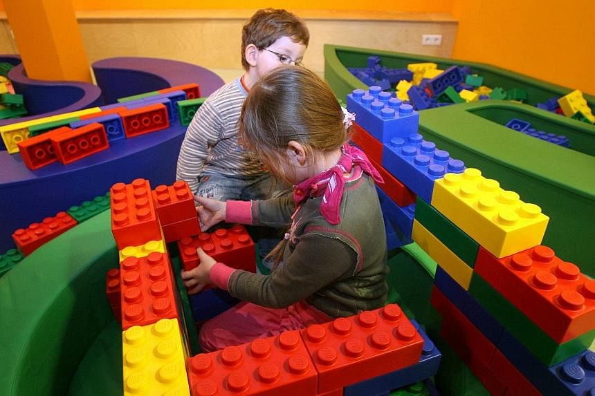 A young girl building a structure with giant rubber Lego bricks at Berlin's Legoland Discovery Centre on March 29, 2010.&nbsp;Danish toy maker Lego has taken the top spot as the world's biggest maker of toys by sales, overtaking Barbie doll-maker Mat