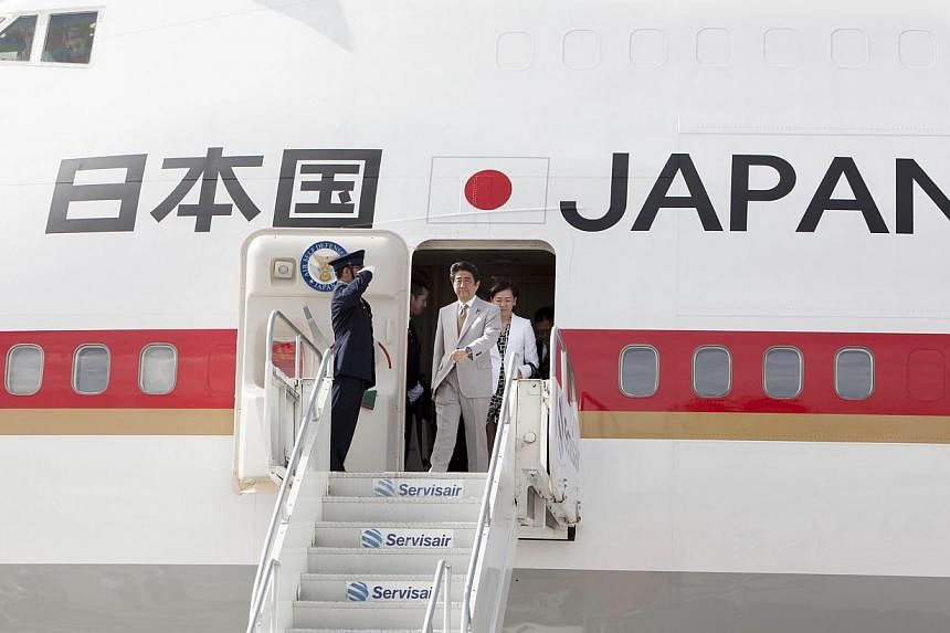 Japanese Prime Minister Shinzo Abe prepares to get off his plane upon his arrival in Port of Spain, Trinidad and Tobago on July 27, 2014. It emerged that details about the flight path and exact location of Mr Abe's plane had been posted on the Intern