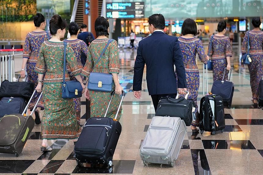 SIA cabin crew at the Changi Airport Terminal 3. -- ST PHOTO: JOYCE FANG
