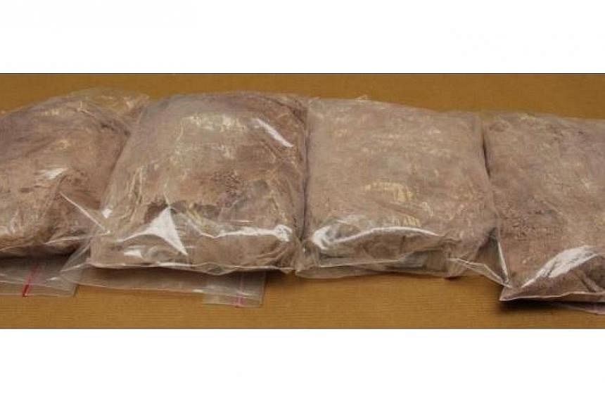 A motorcyclist was caught trying to smuggle nearly 2kg of heroin through Woodlands Checkpoint into Singapore on Wednesday. -- PHOTO: CENTRAL NARCOTICS BUREAU&nbsp;