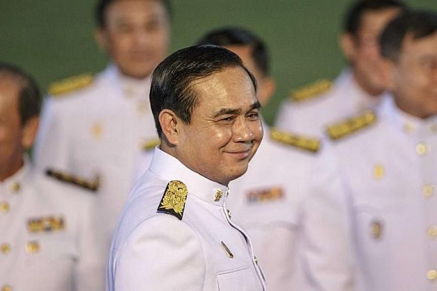 Thailand's Prime Minister Prayuth Chan-ocha smiles after a photo session at Government House following an audience with King Bhumibol Adulyadej at Siriraj Hospital in Bangkok. -- PHOTO: REUTERS