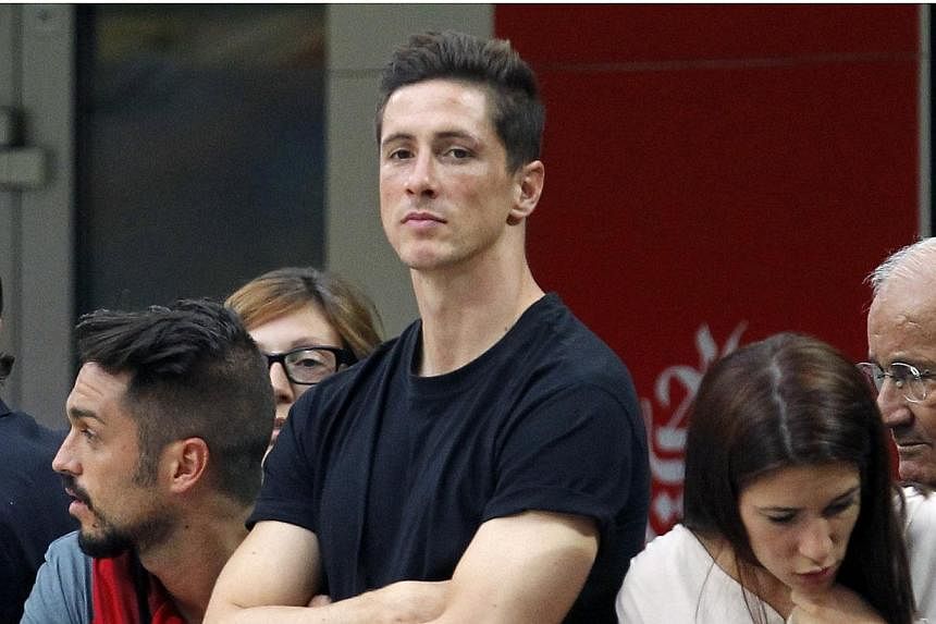 AC Milan's newly signed player Fernando Torres watches their Italian Serie A football match against Lazio at the San Siro stadium in Milan on Aug 31, 2014. -- PHOTO: REUTERS