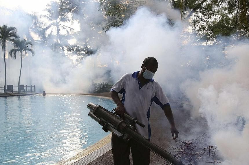 A pest control worker sprays insecticide to help control the spread of dengue fever carried by mosquitoes in Kuala Lumpur on Aug 27, 2014.&nbsp;Malaysia is reeling from a deadly outbreak of dengue, with nearly four times more deaths so far this year 