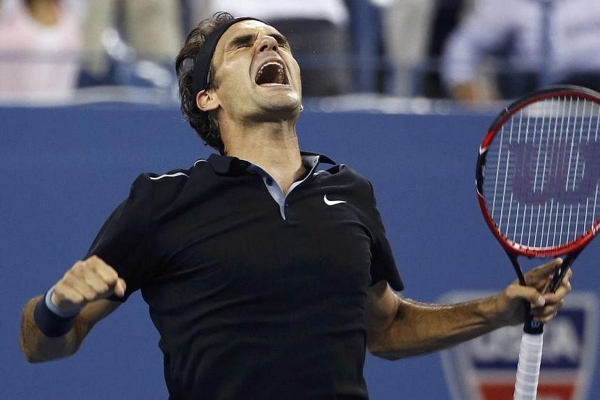 Roger Federer of Switzerland celebrates defeating Gael Monfils of France in the fifth set of their quarter-final men's singles match at the 2014 US Open tennis tournament in New York on Sept 4, 2014. Federer battled back from two sets down and double