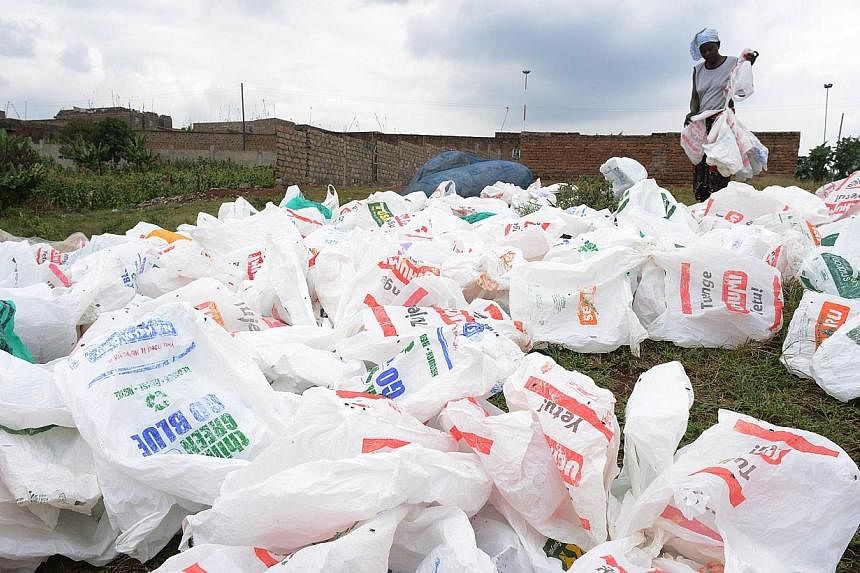 A woman sorts out plastic bags after washing them for re-use at the shores of a river on June 24, 2014, in Nairobi.&nbsp;California Governor Jerry Brown said late on Thursday that he would approve a ban on single-use plastic bags, in what would make 