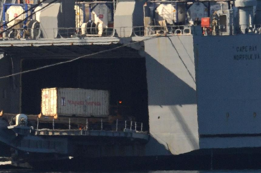 Containers of Syrian chemical weapons from a Danish freighter are transferred to a US military ship ahead of their destruction at sea in the port of Gioia Tauro, southern Italy&nbsp;on July 2, 2014. -- PHOTO: AFP