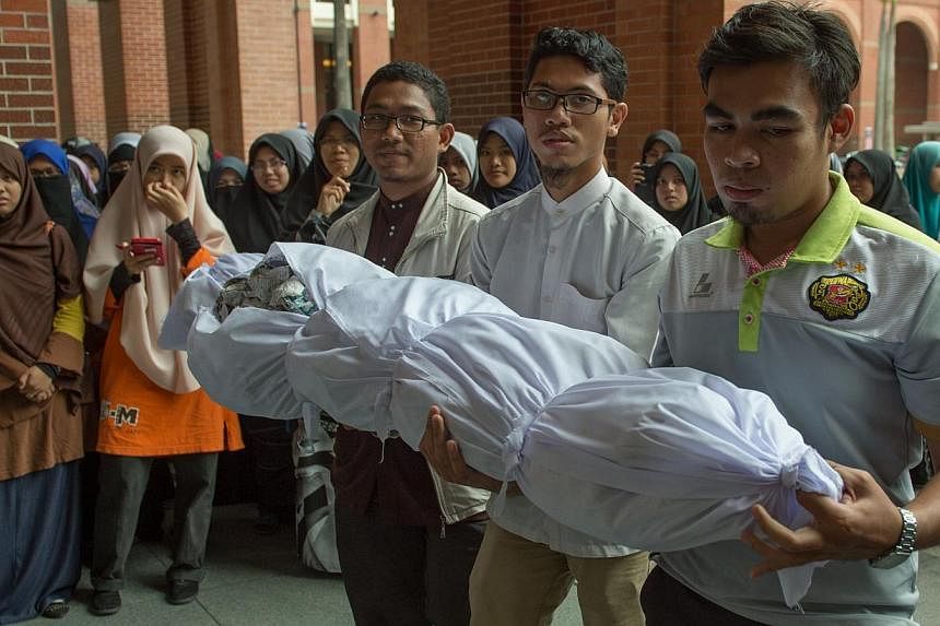 Malaysian students carrying a mock dead body during a protest against the sedition law outside the Ministry of Home Affairs building in Putrajaya, outside Kuala Lumpur on Sept 5, 2014. A Malaysian court on Sept 5 sentenced a student activist to 10 mo