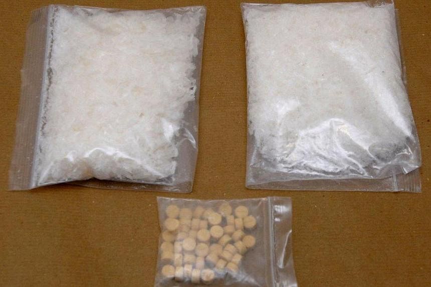 A close-up shot of the Ice and Ecstasy tablets that were seized in a CNB operation on Sep 5, 2014.&nbsp;-- PHOTO:&nbsp;CENTRAL NARCOTICS BUREAU