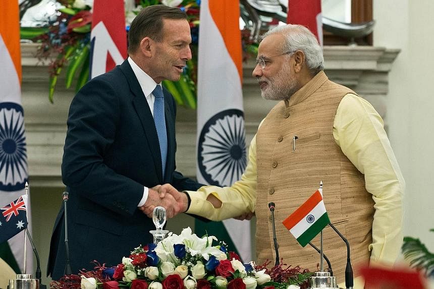 Indian Prime Minister Narendra Modi (right) shakes hands with Australian Prime Minister Tony Abbott after a signing ceremony for the Agreement of Cooperation in the Peaceful Uses of Nuclear Energy in New Delhi on Sept 5, 2014. Conservative leaders To