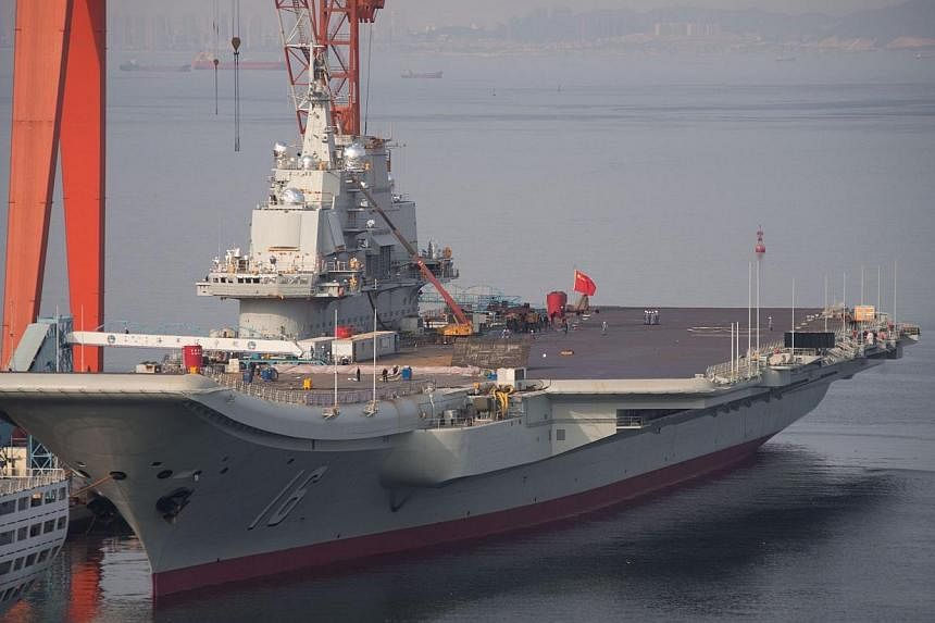 The Chinese aircraft carrier Liaoning docked at the seaport city of Dalian in northeast China's Liaoning province on July 6, 2014.&nbsp;Two pilots in a squadron conducting fighter jet take-off and landing tests for China's lone aircraft carrier were 
