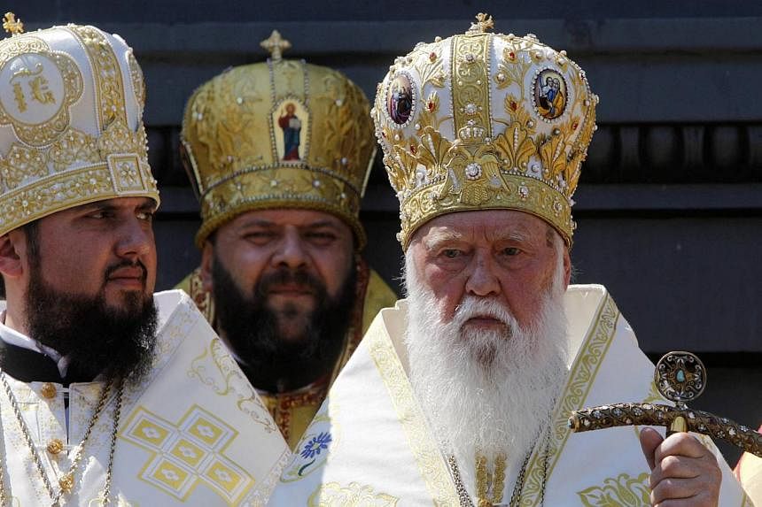 Patriarch Filaret (right), the head of the Ukrainian Orthodox Church of Kiev, takes part in a festive ceremony marking the 1,026th anniversary of the Christianisation of Kievan Rus', in Kiev on July 28, 2014.&nbsp;Russian President Vladimir Putin has