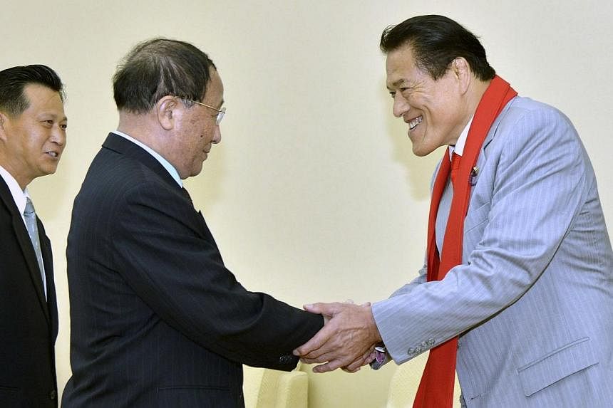 Mr Kang Sok Ju (centre), secretary of the Central Committee of the Workers' Party of Korea (WPK) and advisor to the North Korea-Japan Friendship Association, shakes hands with Kanji Inoki, a member of Japan's House of Councillors in this undated phot