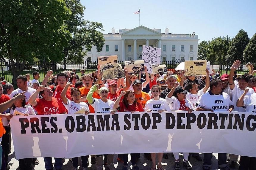 Immigrant rights activists shout slogans in front of the White House on Aug 28, 2014 in Washington, DC.&nbsp;United States President Barack Obama will wait until after November's mid-term elections to reform the US immigration system, in a clear bid 