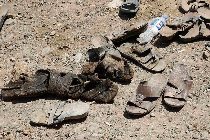 The shoes of men who were recently dug up from a mass grave are seen outside the town of Sulaiman Pek in northern Iraq on Sept 5, 2014. -- PHOTO: REUTERS