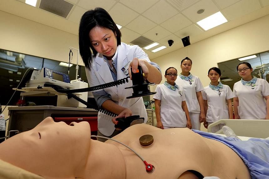 Nurse educator Kathy Lam demonstrates how to perform resuscitation at the Khoo Teck Puat Hospital. People looking to make the mid-career switch to become nurses, physiotherapists, occupational therapists or diagnostic radiographers, can now look forw