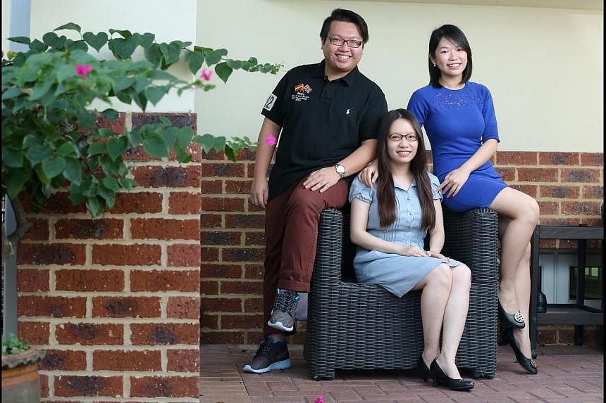 Lawyer Janis Leong (centre), 31, and her sister Rachel, 24, are law graduates of the University of Liverpool. Their brother Gary, 25, is now pursuing the same degree at the university.