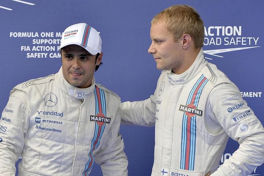 Finland's Valtteri Bottas (right) and Brazilian Felipe Massa will race for Williams again next season in an unchanged line-up, the Formula One team said on Sunday. -- PHOTO: AFP