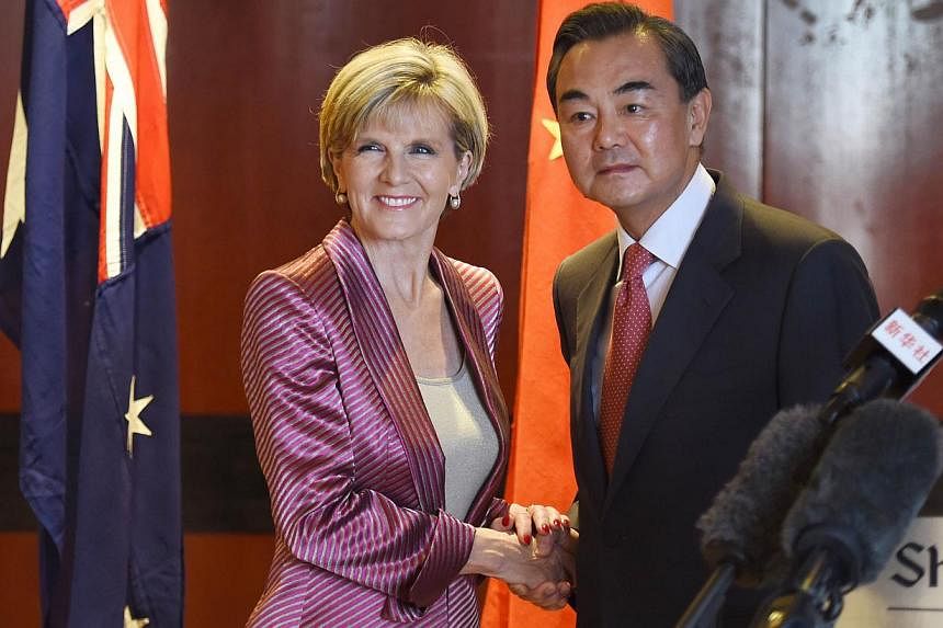 Australian Minister for Foreign Affairs Julie Bishop (left) and Chinese Foreign Minister Wang Yi (right) shake hands after giving opening remarks before the next round of the Australia-China Foreign and Strategic Dialogue in Sydney on Sept 7, 2014. -