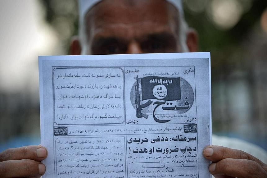 This photograph taken on Sept 3, 2014, shows a Pakistani man holding a pamphlet, allegedly distributed by the Islamic State&nbsp;of Iraq and Syria (ISIS), in the north-western Pakistani city of Peshawar.&nbsp;Afghan and Pakistani nationals who were p