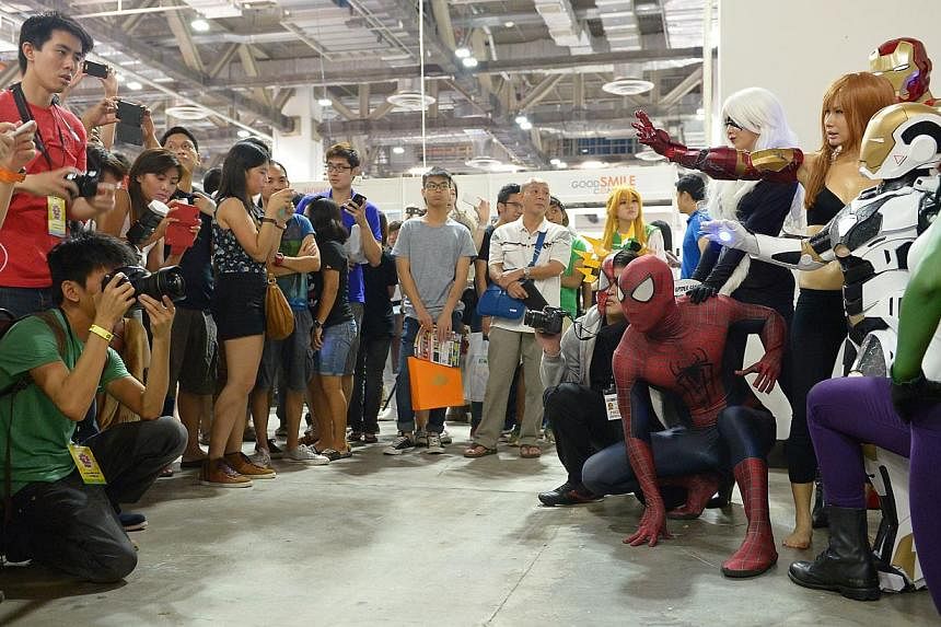 Cosplayers (left) at the Singapore Toy, Game & Comic Convention drew plenty of attention from visitors.