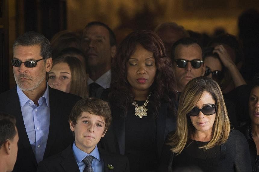 Melissa Rivers and her son Cooper depart the funeral of her mother, comedian Joan Rivers, at Temple Emanu-El in New York on Sept 7, 2014. -- PHOTO: REUTERS