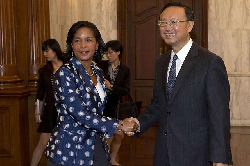 US National Security Advisor Susan Rice (left) shakes hands with Chinese State Councillor Yang Jiechi before a meeting at the Diaoyutai State Guesthouse in Beijing, on Sept 8, 2014. -- PHOTO: REUTERS