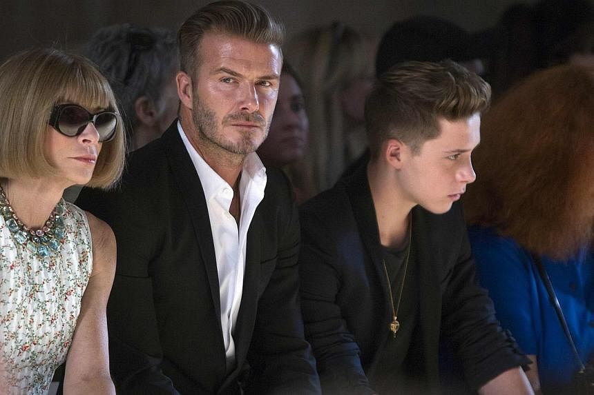 (From left) Vogue editor Anna Wintour, David Beckham and his son Brooklyn Beckham watch a model present a creation during the Victoria Beckham Spring/Summer 2015 collection during New York Fashion Week in the Manhattan borough of New York on Sept 7, 